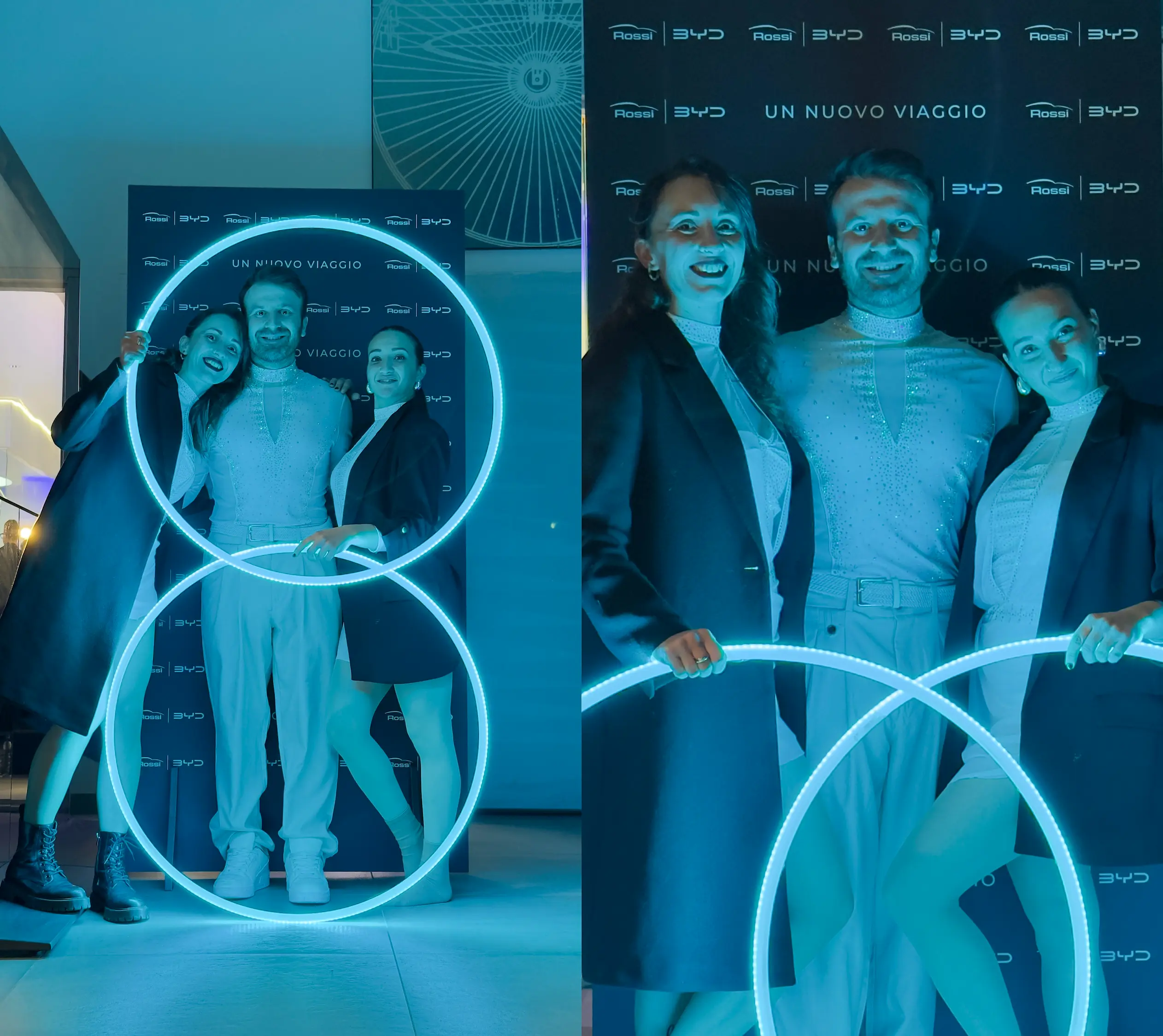 Tre artisti in posa davanti al backdrop BYD Rossi con cerchi a LED azzurri durante un evento di auto reveal in concessionaria.